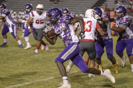 Lemoore's Chris Taylor speeds around end for a first down.